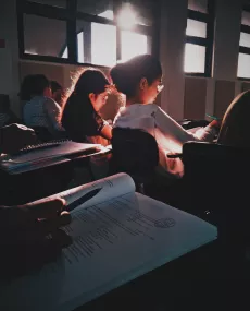 Pupils sitting in a classroom reading