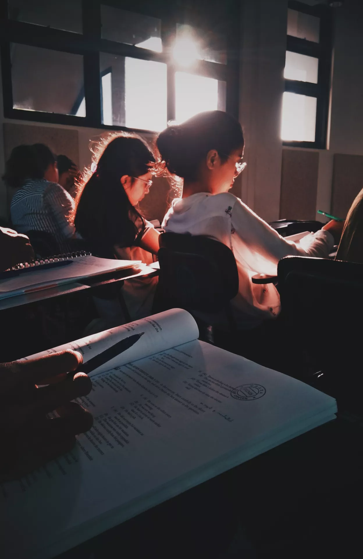 Pupils sitting in a classroom reading